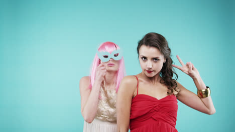 girlfriends dancing wearing red dress and pink hair in slow motion party photo booth