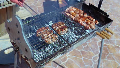 bbq home made sausages and kababs being cooked outside