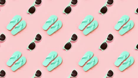 green flip flops and eyeglasses over pink. 4k video