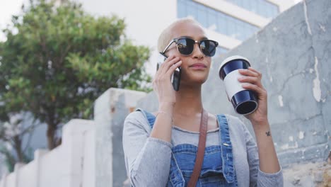 mixed race woman on the phone drinking coffee