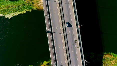 sky view cars driving on highway road over river. highway bridge river