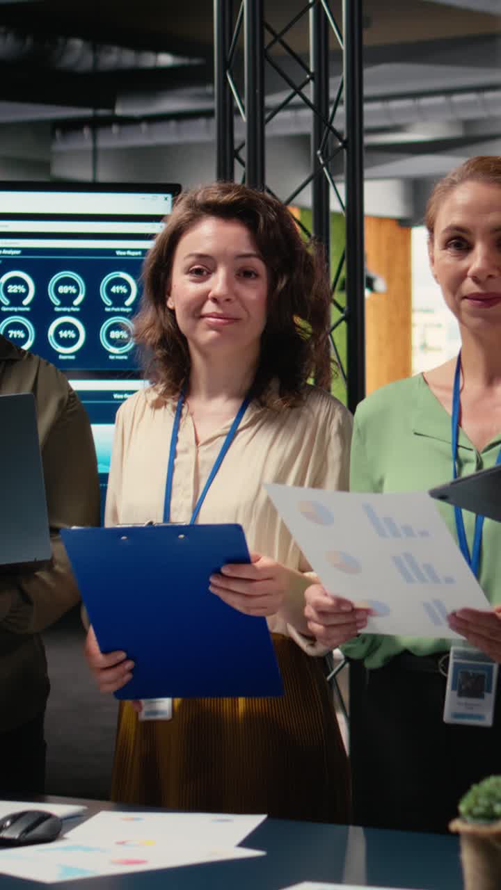Vertical Video Portrait of diverse group of businesswomen collaborating on report writing