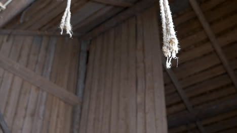 ropes hanging from ceiling in wooden barn,concentration camp barack concept