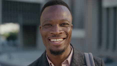 close up portrait happy african american businessman laughing enjoying successful lifestyle professional black entrepreneur in city at sunset slow motion