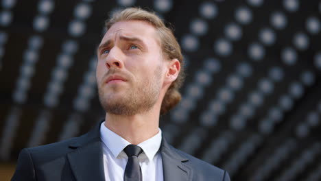 Handsome-guy-waiting-someone-outside.-Businessman-looking-hand-watch-outdoors.