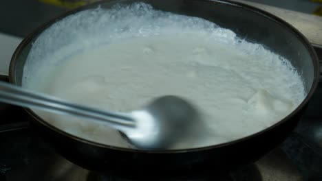 Mixing-Hot-White-Sauce-In-A-Pan