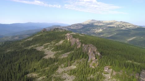 aerial view of rocky mountains with green forest