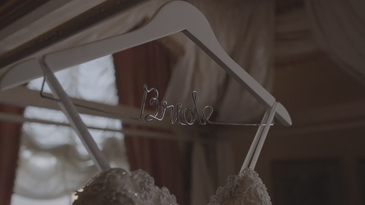 Cinematic slow motion shot of wedding dress hanging in customized bride hanger. Shot in 4K 60FPS for high quality slow motion. Purchase entire event raw at wholesale price email willneatheryyahoo.com