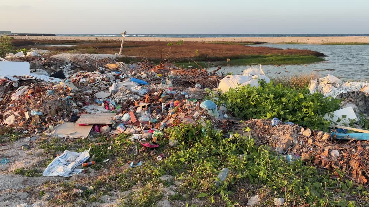 Rubble and Trash Scattered on a Tropical Island Beach plastic