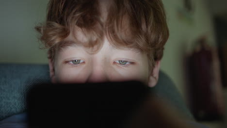 teenager engrossed in his smartphone at night