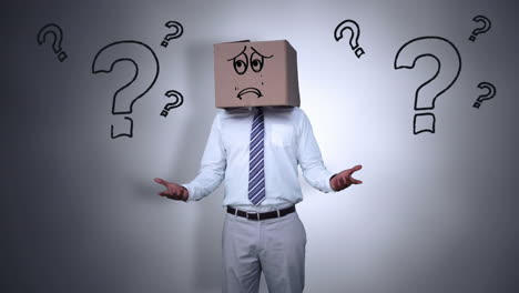 businessman hiding head with sad box