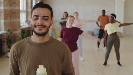 retrato de un joven árabe con una botella de agua en la clase de baile