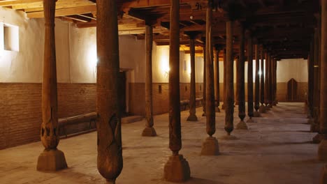 ancient mosque interior with wooden pillars and intricate carvings