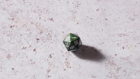 D20-Dice-Of-Dungeons-and-Dragons-Rolling-a-Natural-One---close-up