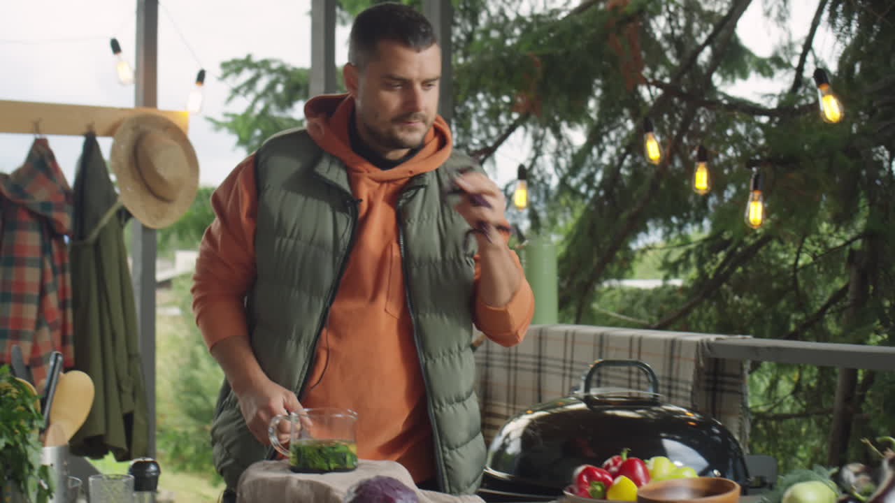 Food Blogger Putting Herb in Teapot and Talking on Camera