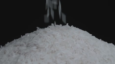 Pile Of White Rice Grain Pouring And Rotating, On A Black Background
