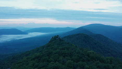 An-aerial-shot-of-Big-Schloss,-Great-North-Mountain-and-the-Trout-Run-Valley-at-dawn-in-the-summer,-located-on-the-Virginia-West-Virginia-Border-within-the-George-Washington-National-Forest