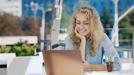 young business woman talking on the video conferencing or video chat using a laptop sitting on the s