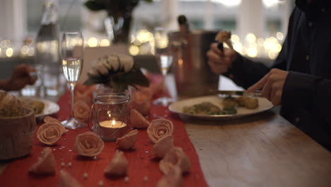 close up of romantic couple enjoying valentines day meal