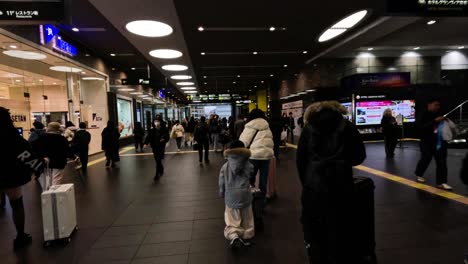 passengers walking through a busy station