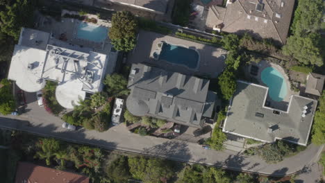 4k drone cork screw pullout shot of backyard swimming pools in the hollywood hills