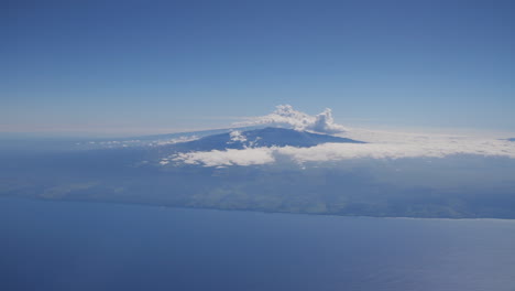 clouds pass by island in hawaii