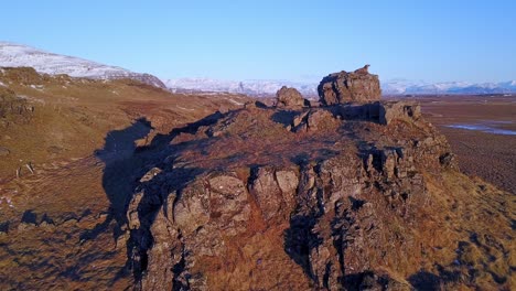 rugged rocks and landscape in iceland with warm sunlight and mountainous background