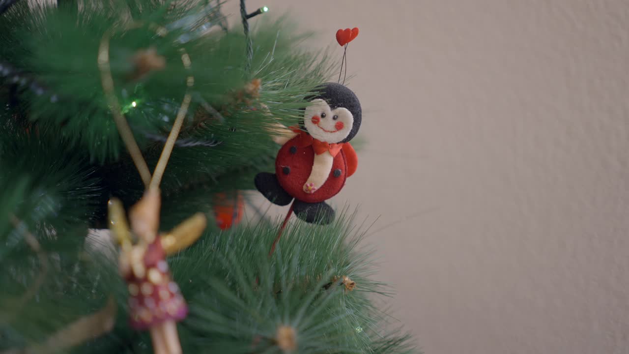 Decorating Christmas Tree with Ladybug Ornament
