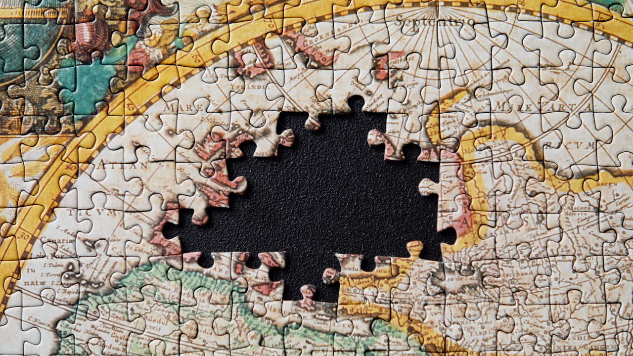 World map puzzle parts on dark flat surface displaying absent segments closeup