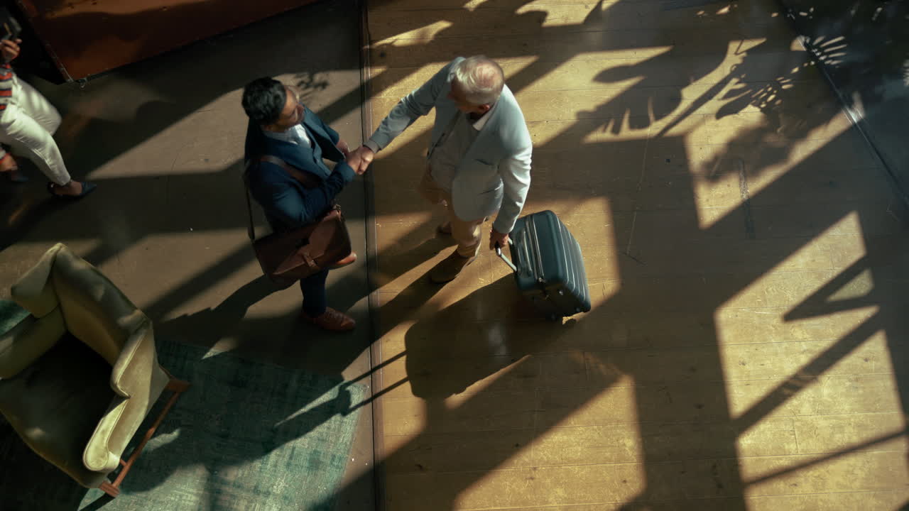 Overhead shot of people in a meeting area with luggage