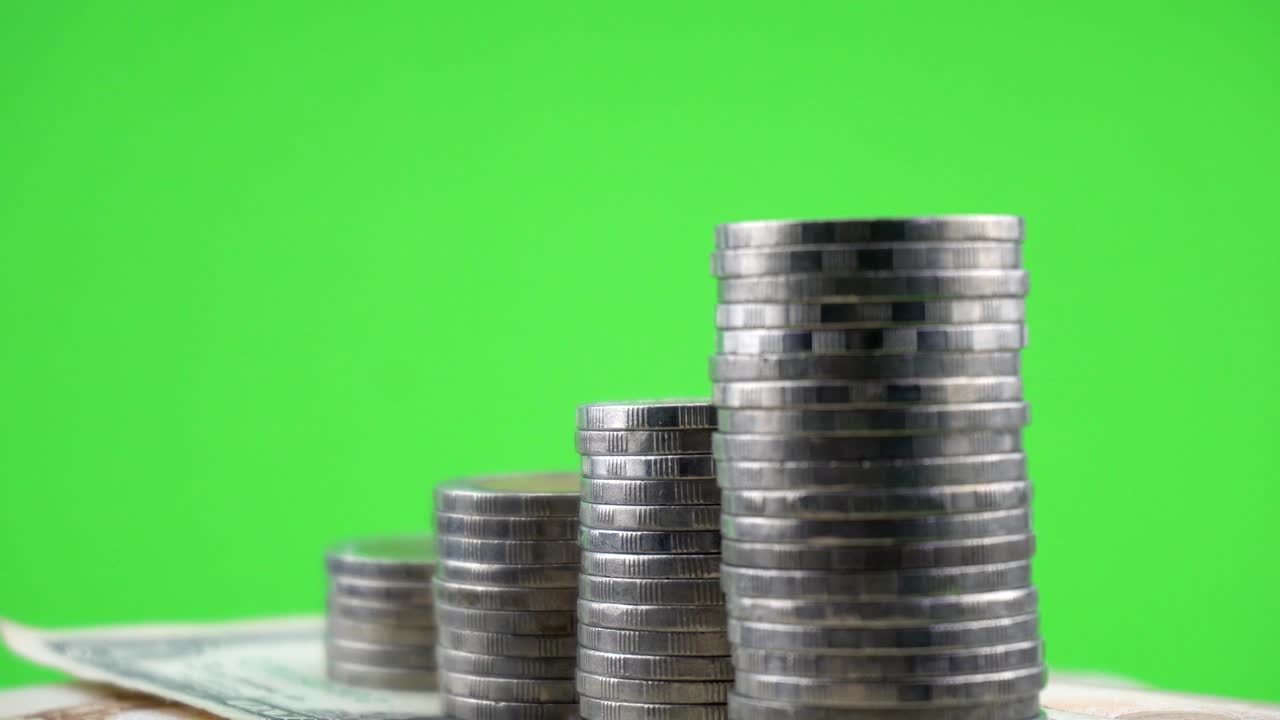 Rotating of coins on money banknote green screen paper background