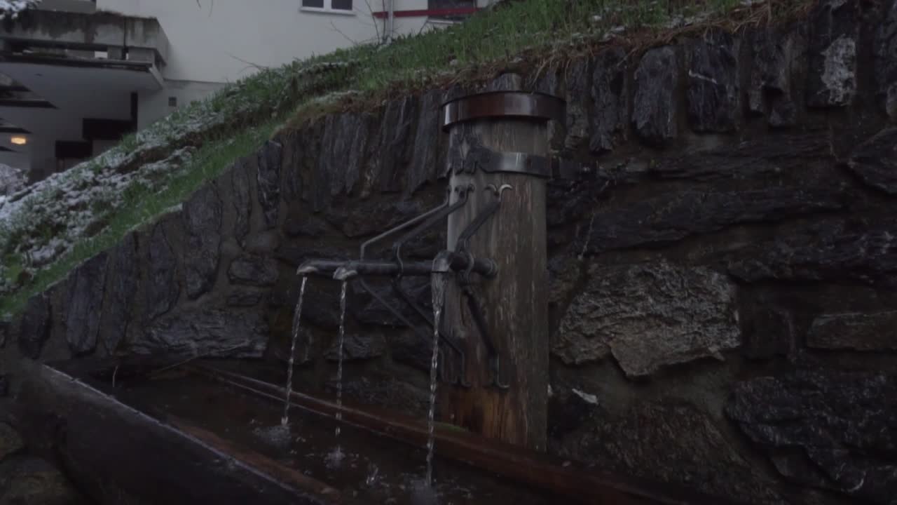 antigua fuente de agua rústica en los alpes
