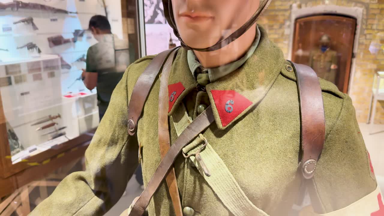 Mannequin in authentic World War II military uniform displayed in museum exhibit, close-up views