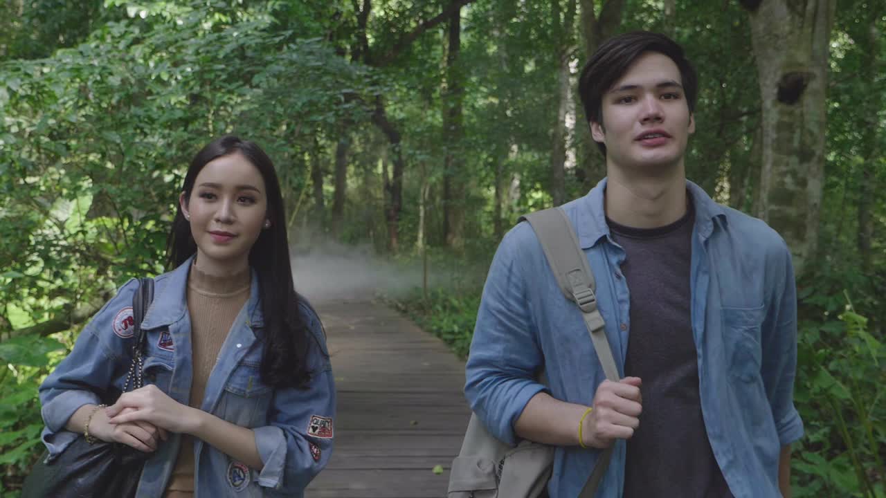 Couple Walking On Wooden Path Through The Forest, Slow Motion
