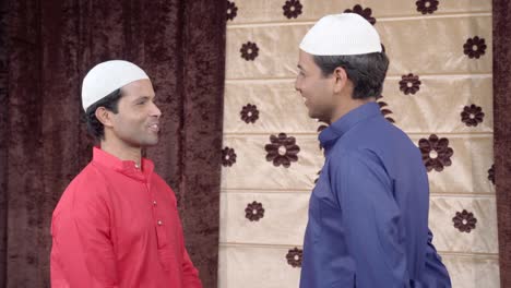 two happy muslim men talking to each other