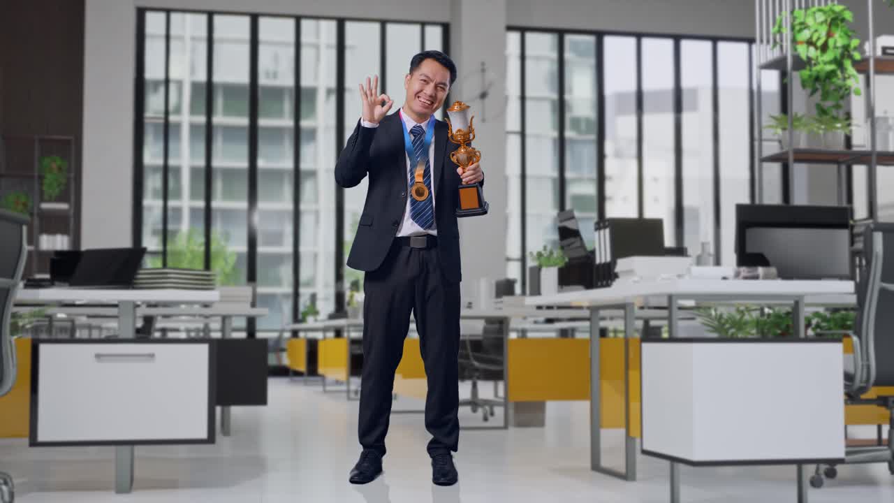 Businessman celebrating award in office