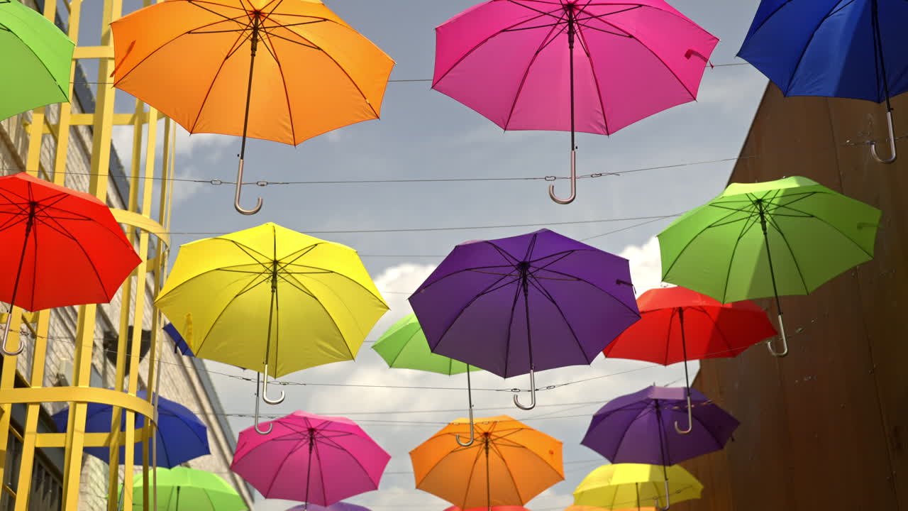 Colorful Umbrellas Hanging Above a Street