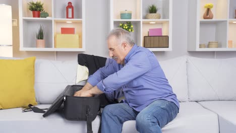 Elderly-man-preparing-for-travel-is-packing-a-bag.