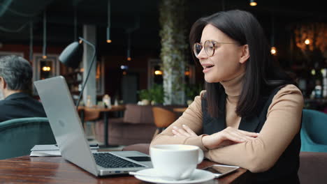 business woman working on laptop in cafe