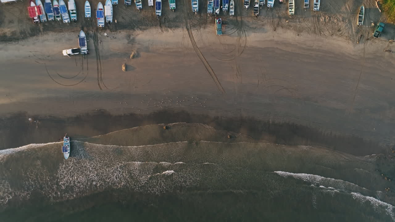 antena ascendente de barcos pesqueros mexicanos varados en la costa arenosa por la mañana, 4k