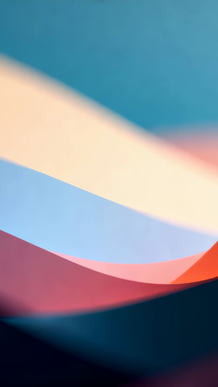 Vertical video: Panning camera shifting layered curved bands in studio closeup, revealing red ridge