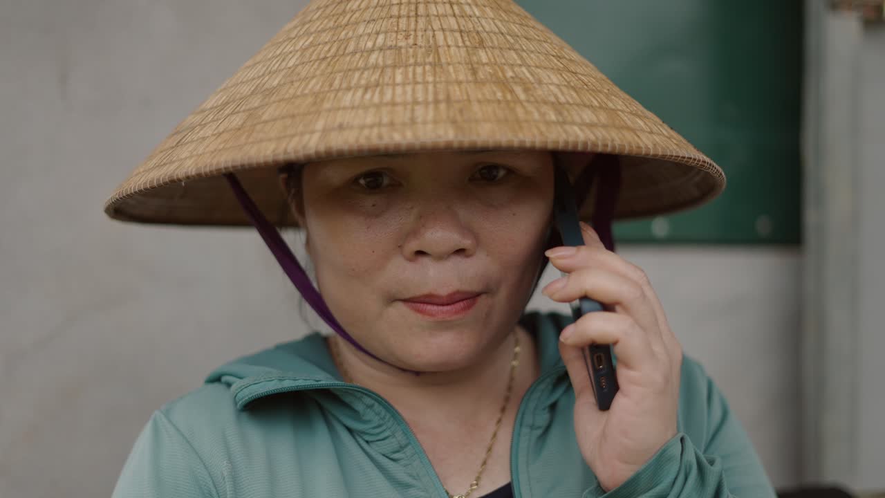 Woman in Straw Hat Talking on Phone