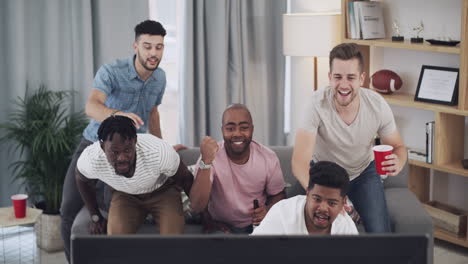 a group of young men watching a sports game