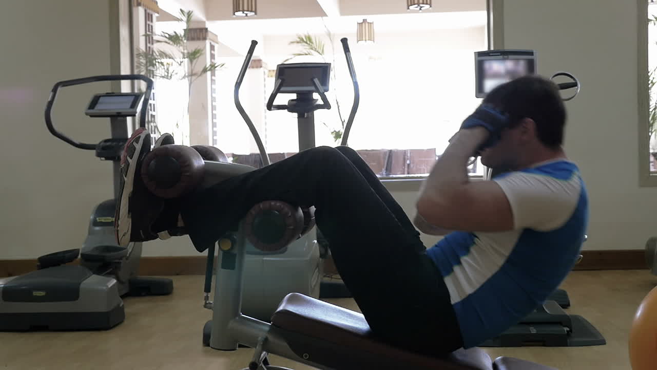 Man doing abs exercise in the gym