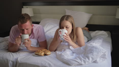 couple enjoying breakfast in bed