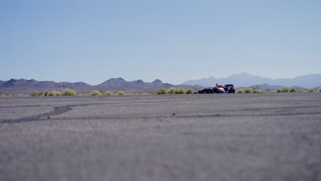 formula 1 car driving down an airport runway in las vegas, nevada