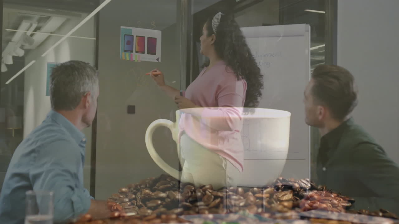 Business team presenting phone mockups on glass wall with sticky notes and viewing coffee mug