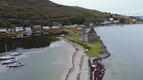 aerial view of lochranza castle on the isle of arran on an overcast day, scotland