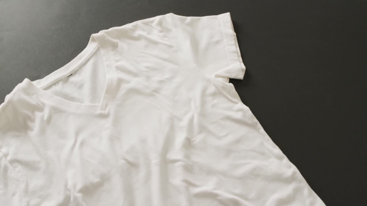 Video of close up of white t shirt on black background