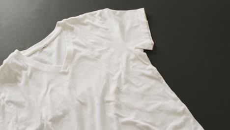 video of close up of white t shirt on black background